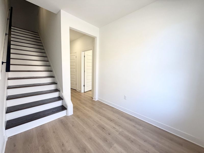 Stairs featuring wood finished floors and baseboards