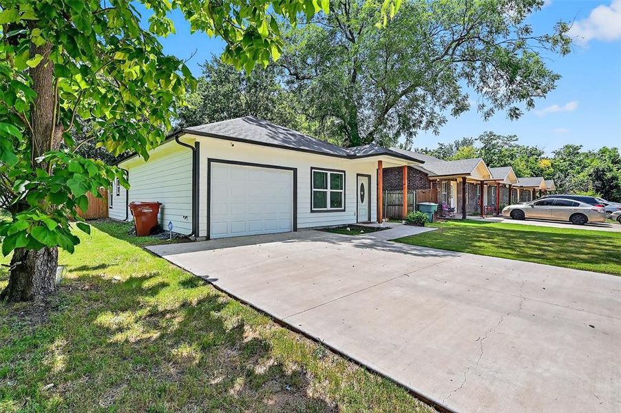 Ranch-style house featuring a garage, concrete driveway, a front yard, and roof with shingles Ranch-style house featuring a garage, concrete driveway, a front yard, and roof with shingles