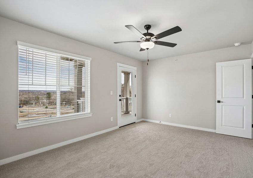 The master bedroom has a ceiling fan and deck.