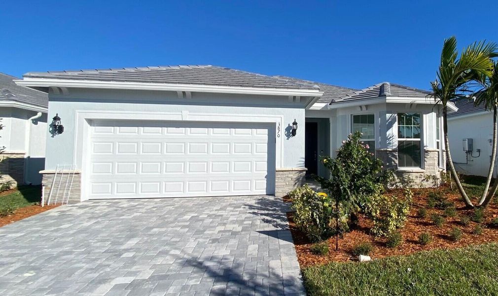 Front exterior of a new home in Costa Pointe, Vero Beach, FL, highlighting curb appeal (Image 17).
