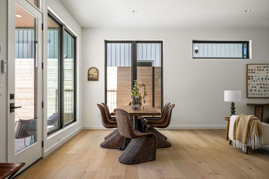 Gleaming wood floors and abundant natural light define this inviting dining area.