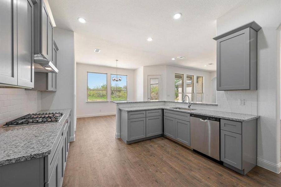 Kitchen featuring gray cabinetry, appliances with stainless steel finishes, sink, and plenty of natural light