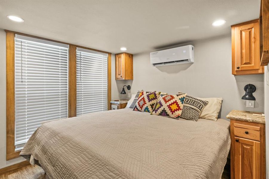 Bedroom featuring recessed lighting and a wall mounted air conditioner
