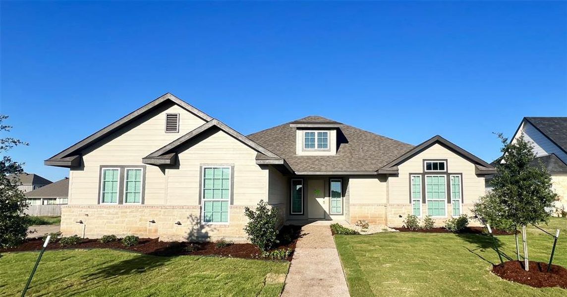 View of front of house featuring roof with shingles, a front lawn, and stone siding View of front of house featuring roof with shingles, a front lawn, and stone siding