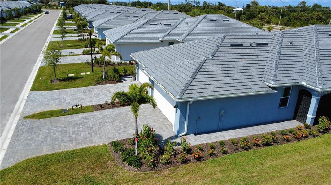 Front exterior of a new home in Palm Lake at Coco Bay, Englewood, FL, highlighting curb appeal (Image 18). Front exterior of a new home in Palm Lake at Coco Bay, Englewood, FL, highlighting curb appeal (Image 18).