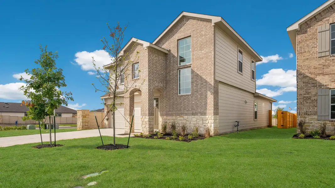 Front exterior of a new home in Prairie Lakes, Buda, TX, highlighting curb appeal (Image 2).