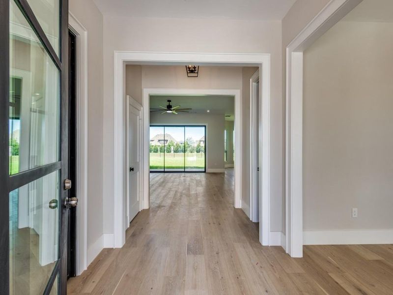 Entryway with study office on left behind iron glass doors