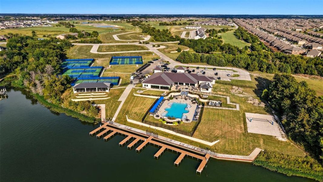 Aerial overview of property's location with a nearby body of water and a pool area Aerial overview of property's location with a nearby body of water and a pool area