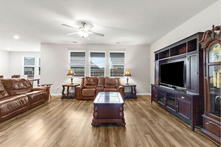 Living area with ceiling fan, wood finished floors, and recessed lighting Living area with ceiling fan, wood finished floors, and recessed lighting