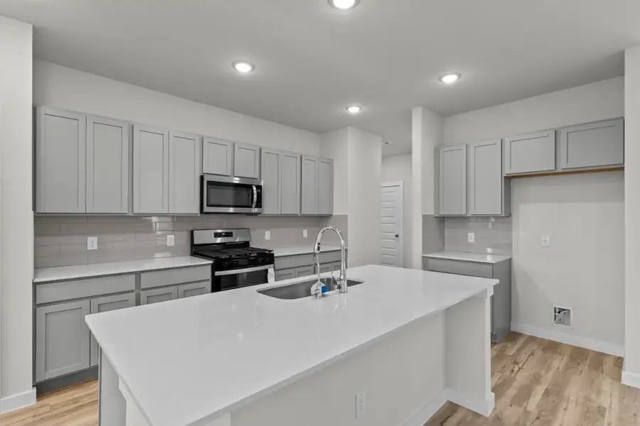 A kitchen with white cabinets. A kitchen with white cabinets.