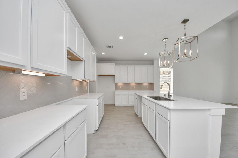 The kitchen is a culinary haven, featuring granite countertops, a tile backsplash, stainless steel appliances, 42” upper cabinets, and undercabinet lighting.