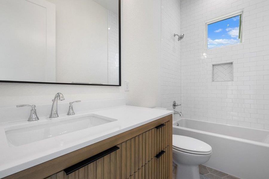 Bathroom featuring a vanity with a white countertop, chrome fixtures, and a large mirror