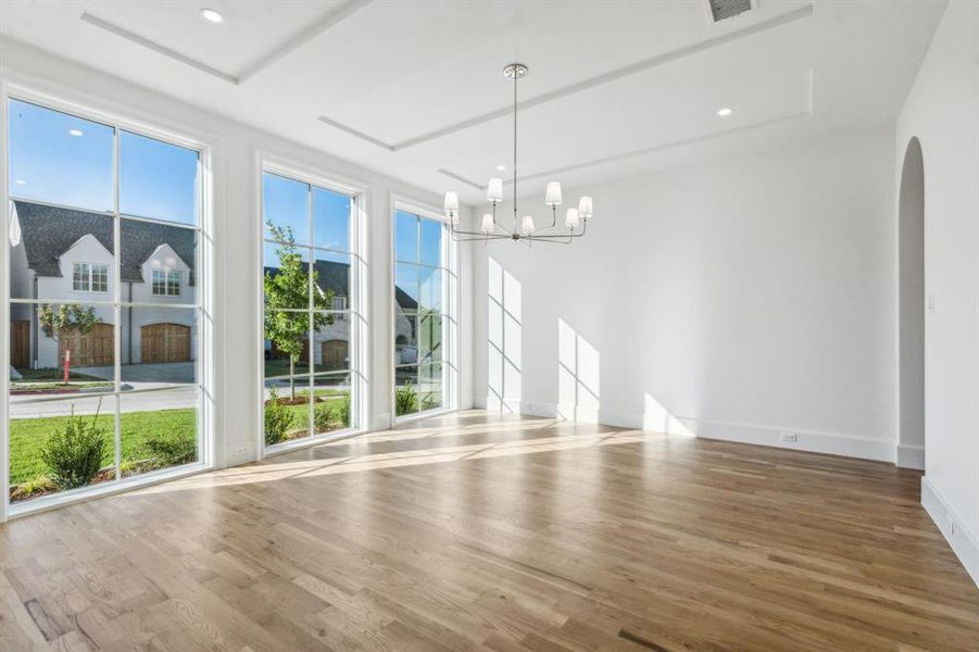 Dining area with hardwood floors and a chandelier