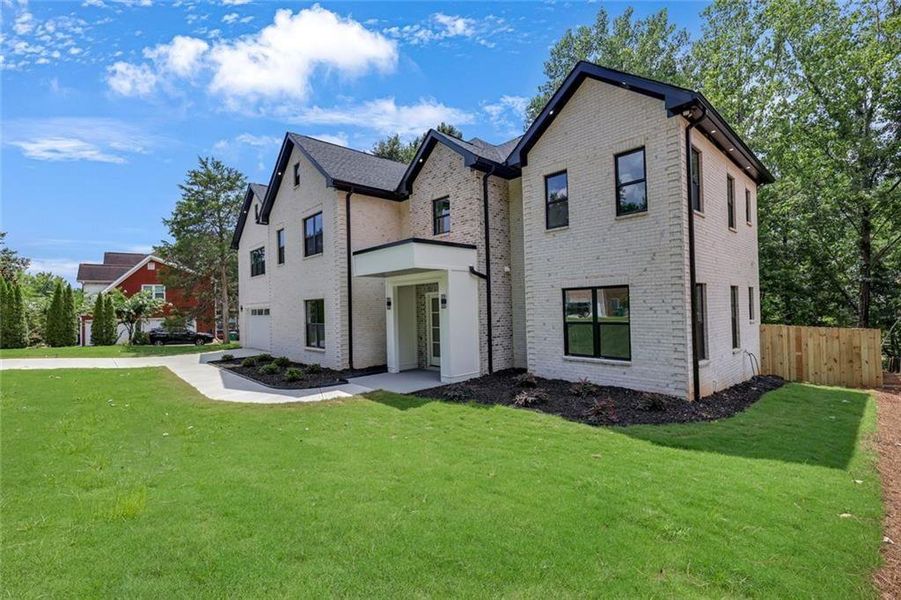 Front exterior of a new home in , Snellville, GA, highlighting curb appeal (Image 33). Front exterior of a new home in , Snellville, GA, highlighting curb appeal (Image 33).