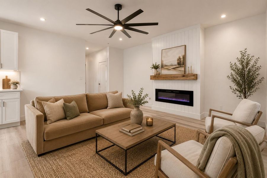 Virtually staged living room area featuring a shiplap accent wall with an inset electric fireplace and wood mantle