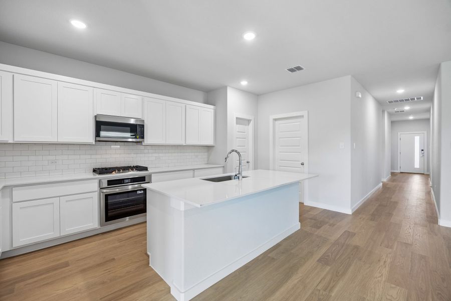 Kitchen in the Oscar home plan by Trophy Signature Homes – REPRESENTATIVE PHOTO