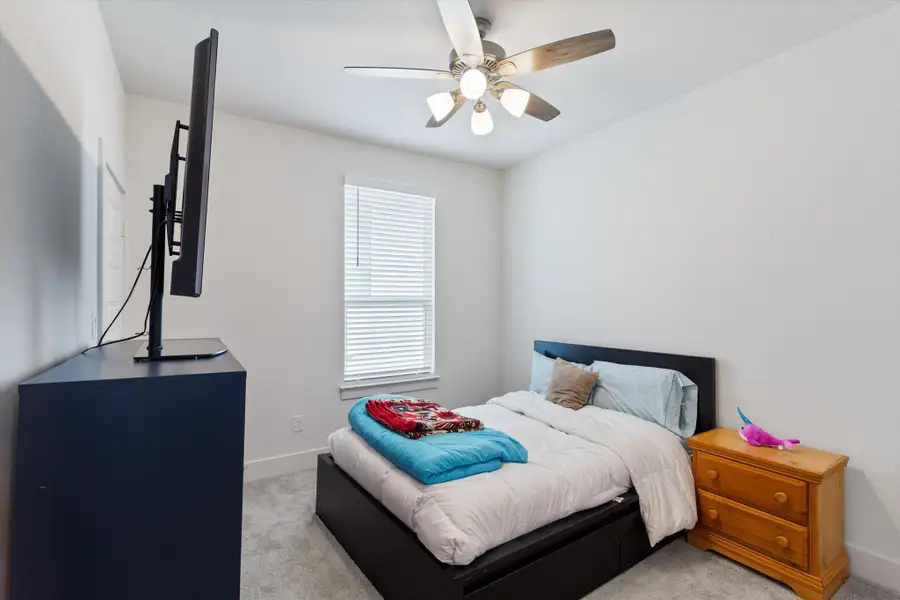 Bedroom featuring carpet and a ceiling fan