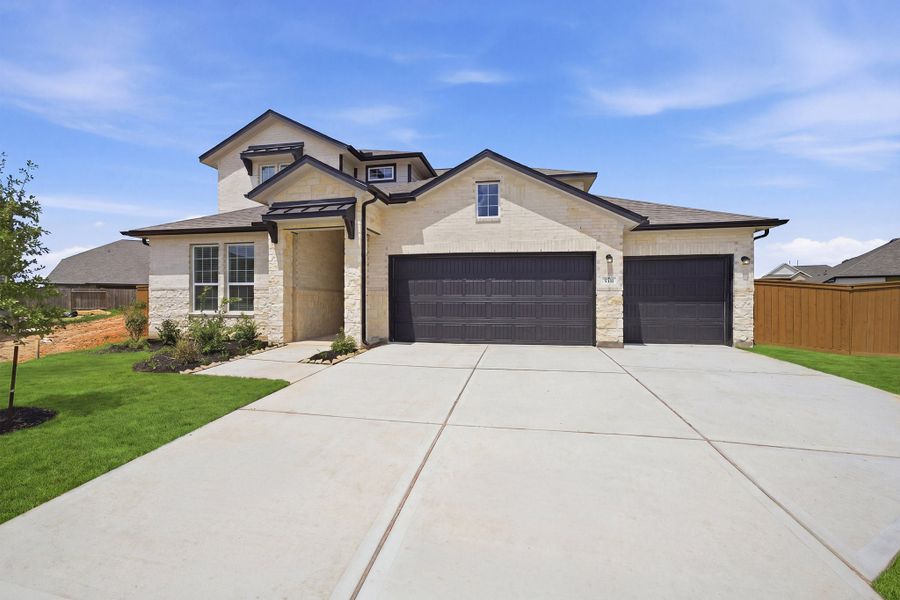Front exterior of a new home in Sunterra, Katy, TX, highlighting curb appeal (Image 20). Front exterior of a new home in Sunterra, Katy, TX, highlighting curb appeal (Image 20).