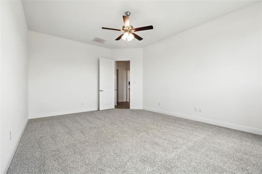 Spare room with light carpet and ceiling fan