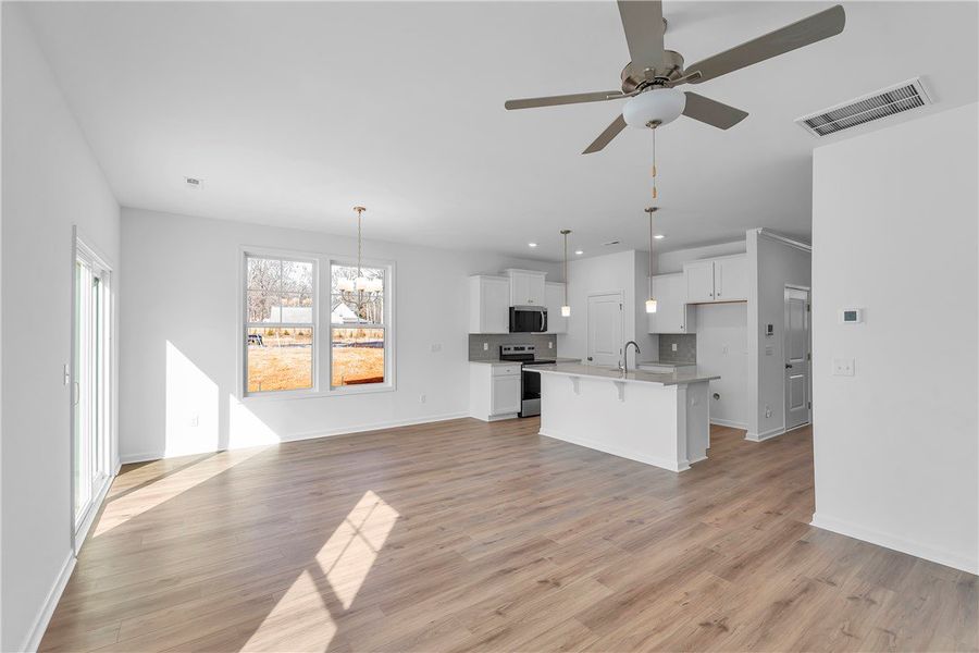 Bright, open-concept living space with sleek floor