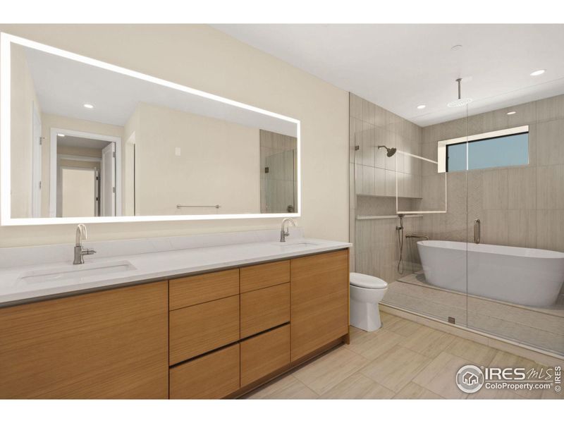 Double sink, back lit mirror and a European style shower/bath combo room.