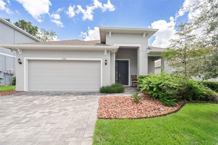 Front exterior of a new home in Summerbrooke, Mount Dora, FL, highlighting curb appeal (Image 1). Front exterior of a new home in Summerbrooke, Mount Dora, FL, highlighting curb appeal (Image 1).