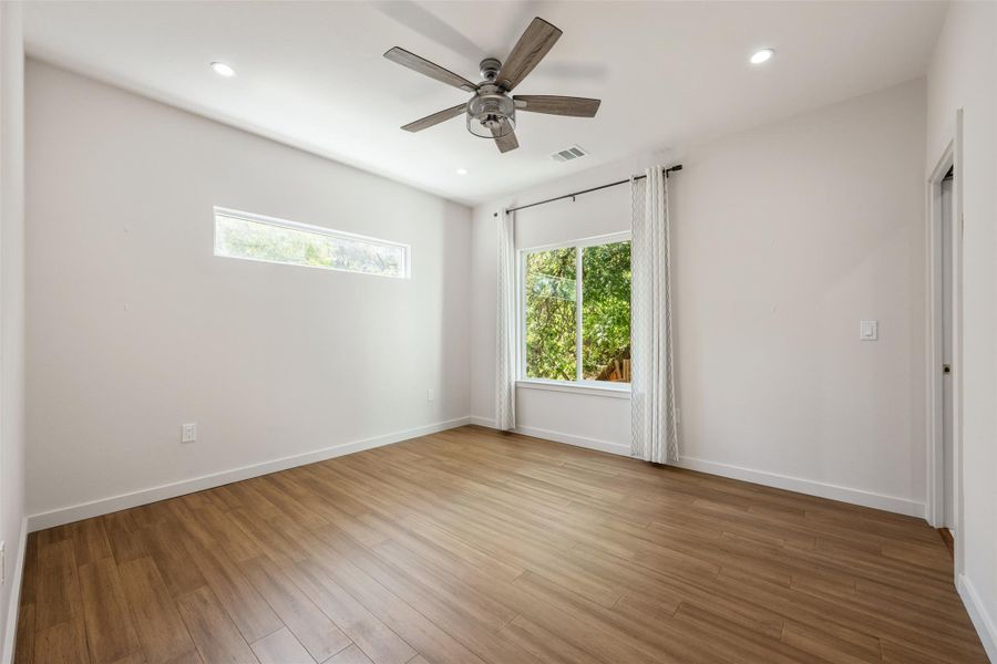 Empty room with recessed lighting, wood finished floors, and ceiling fan