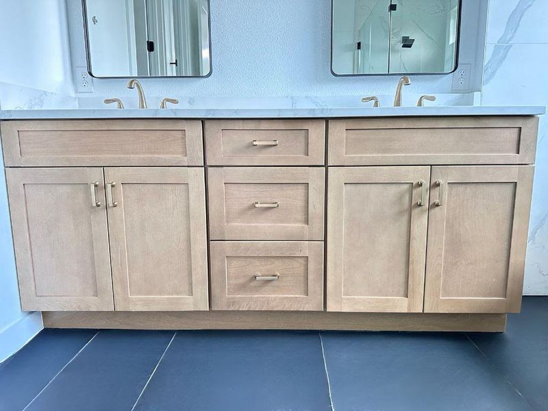 Double vanity with sleek cabinetry and dual mirrors elevates the modern bathroom aesthetic. Double vanity with sleek cabinetry and dual mirrors elevates the modern bathroom aesthetic.