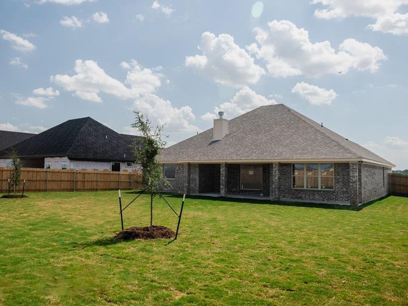 Back of property with a fenced backyard, brick siding, a patio, and a chimney Back of property with a fenced backyard, brick siding, a patio, and a chimney