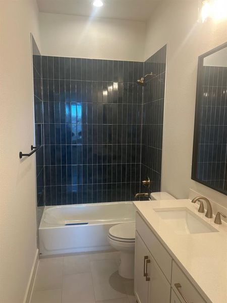Second bathroom with tile surround over tub