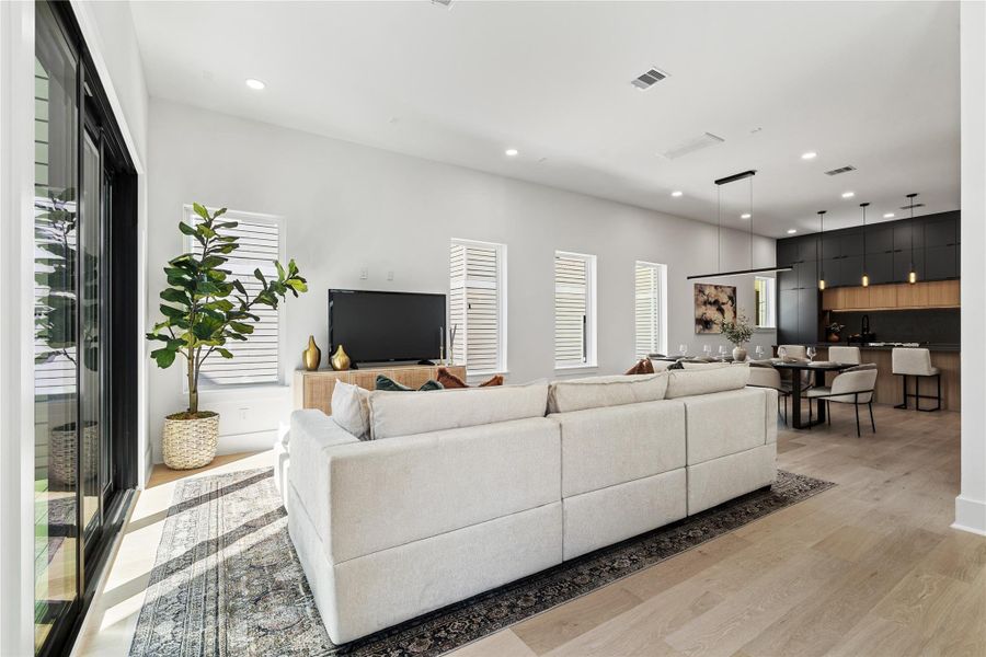 Bold, contrasting tones are softened by natural wood finishes and abundant sunlight, creating a space that feels both grounded and modern. The open layout encourages seamless movement between kitchen, dining, and living areas. Bold, contrasting tones are softened by natural wood finishes and abundant sunlight, creating a space that feels both grounded and modern. The open layout encourages seamless movement between kitchen, dining, and living areas.