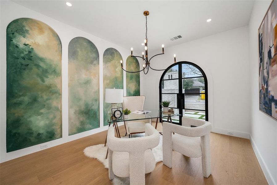 Dining space with suspended lighting and light wood finished floors Dining space with suspended lighting and light wood finished floors