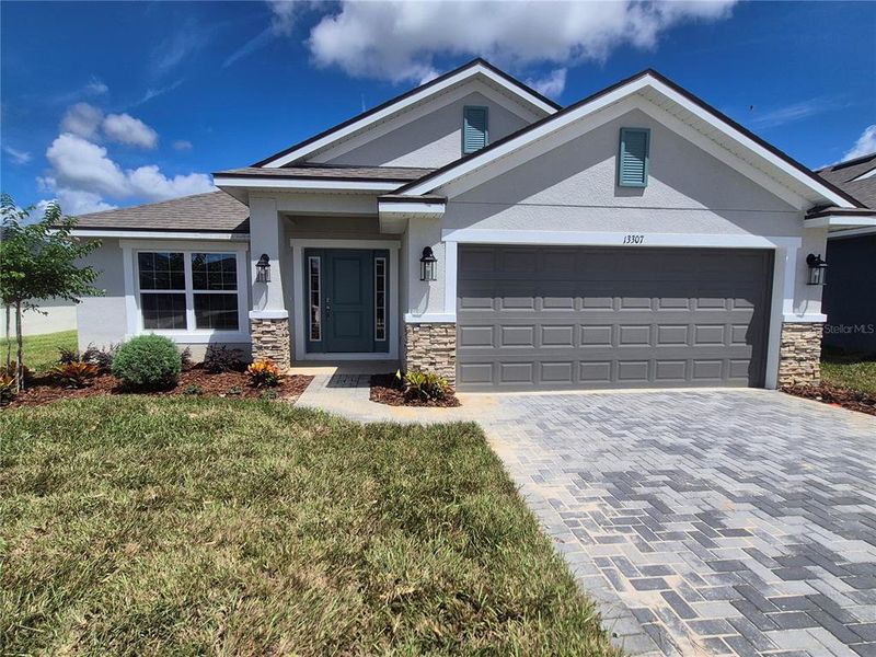 Front exterior of a new home in Abbey Glen, Dade City, FL, highlighting curb appeal (Image 17).