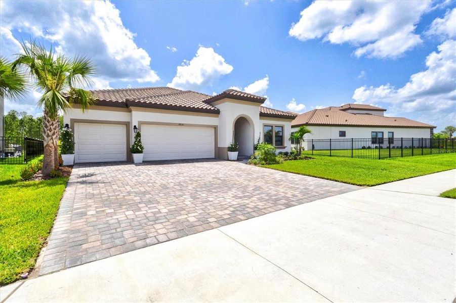 Front exterior of a new home in Crosswind Ranch, Parrish, FL, highlighting curb appeal (Image 33).