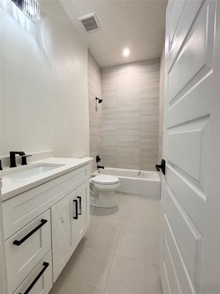 A well-appointed bath features a sleek vanity, tiled flooring, and modern fixtures. A well-appointed bath features a sleek vanity, tiled flooring, and modern fixtures.