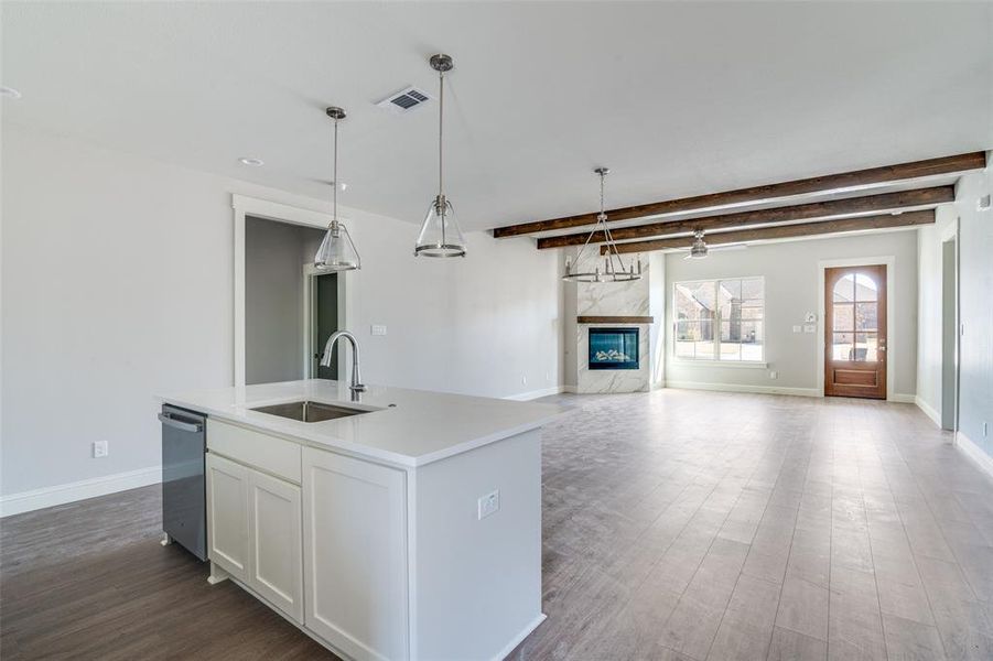 The kitchen has a single bowl sink with brushed nickel fixtures.