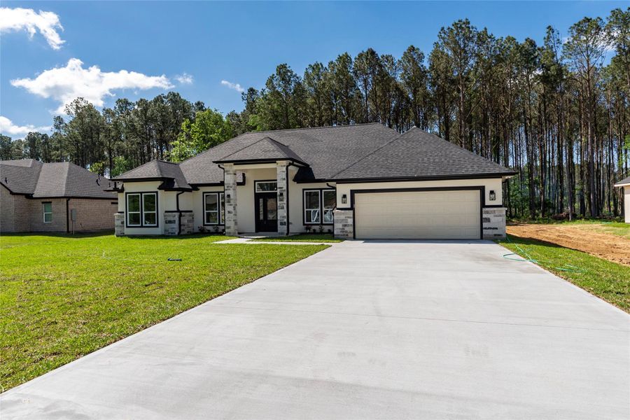 Front exterior of a new home in , Dayton, TX, highlighting curb appeal (Image 1).
