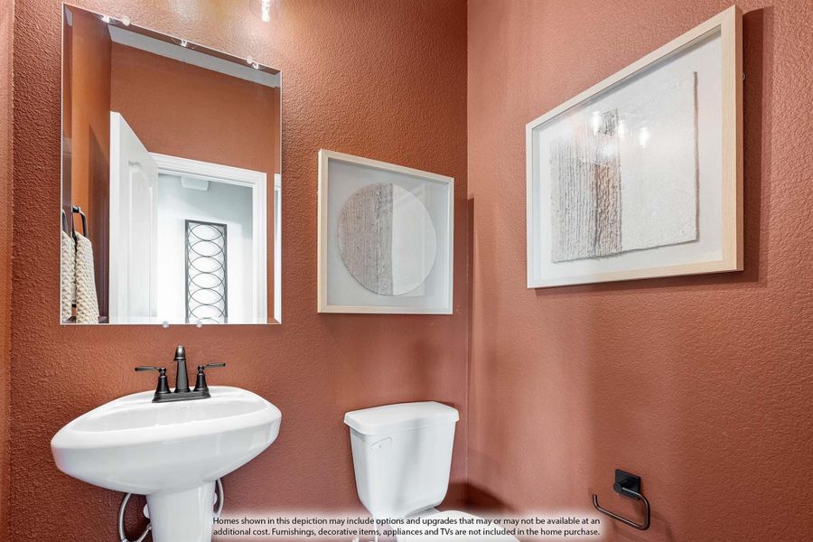 Powder room with pedestal sink, large mirror, and terracotta-colored textured walls Powder room with pedestal sink, large mirror, and terracotta-colored textured walls