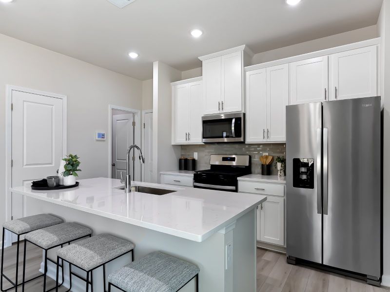 A large kitchen island overlooks the sprawling great room, perfect for entertaining.