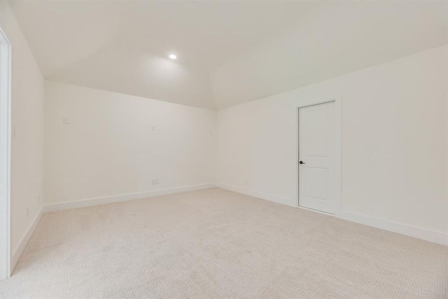 Spare room with light colored carpet, vaulted ceiling, and recessed lighting Spare room with light colored carpet, vaulted ceiling, and recessed lighting