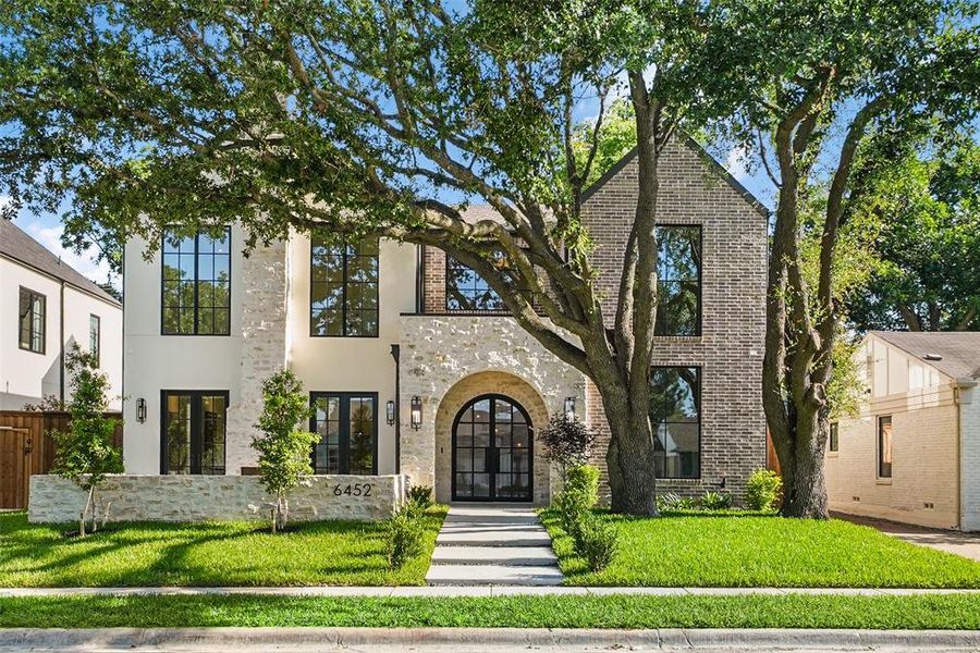 Contemporary architectural facade featuring mixed stone and brick cladding