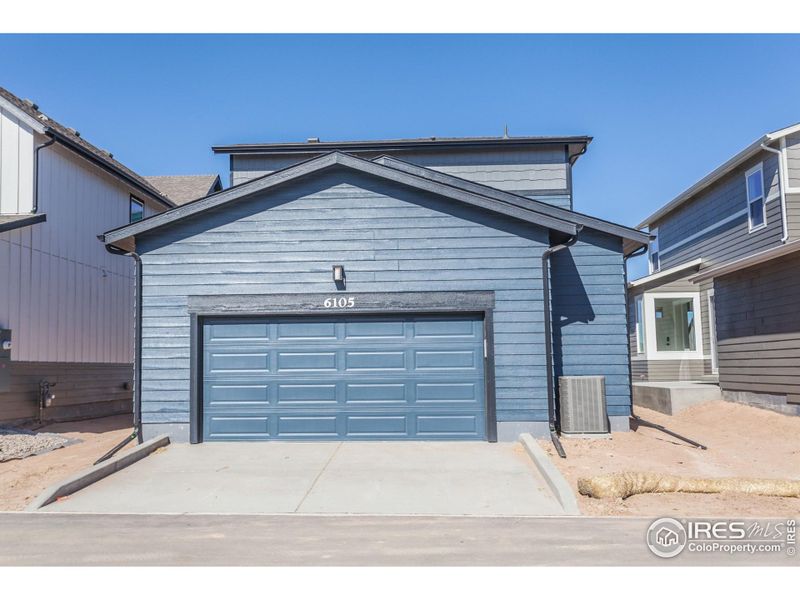 Front exterior of a new home in Trailside Alley Load - Single Family Homes, Timnath, CO, highlighting curb appeal (Image 25).