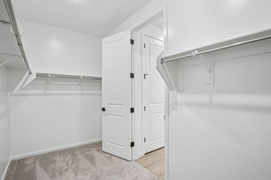 Primary walk in closet - Stonebridge Model Home. Finishes and options may vary by community