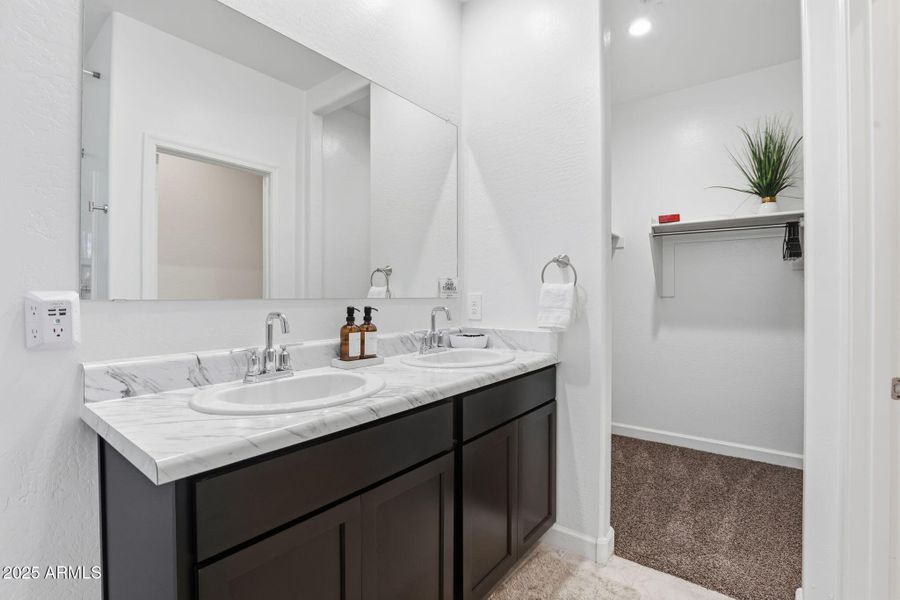 Master bath has double sinks and extra l