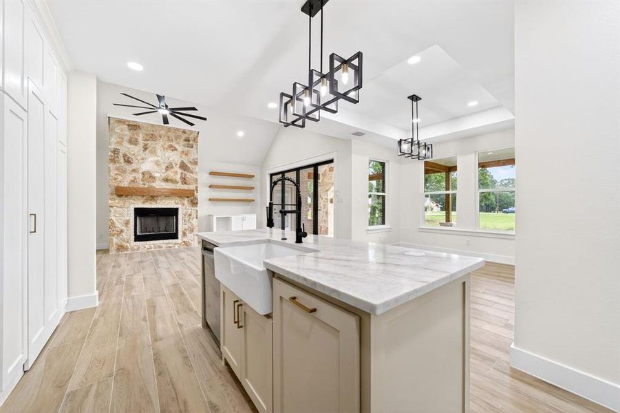 Kitchen island with a farmhouse sink and stone-finish countertop Kitchen island with a farmhouse sink and stone-finish countertop