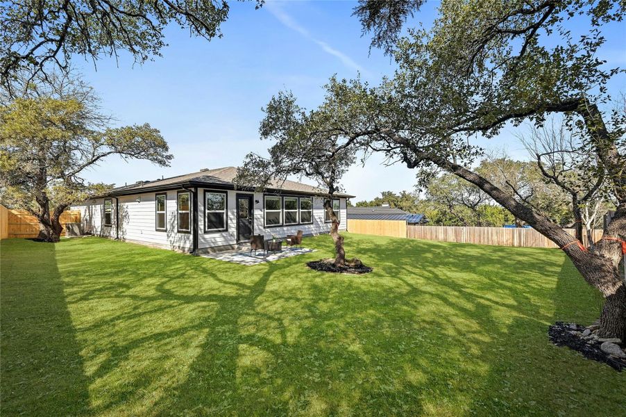 aother angle of the backyard with mature oak trees