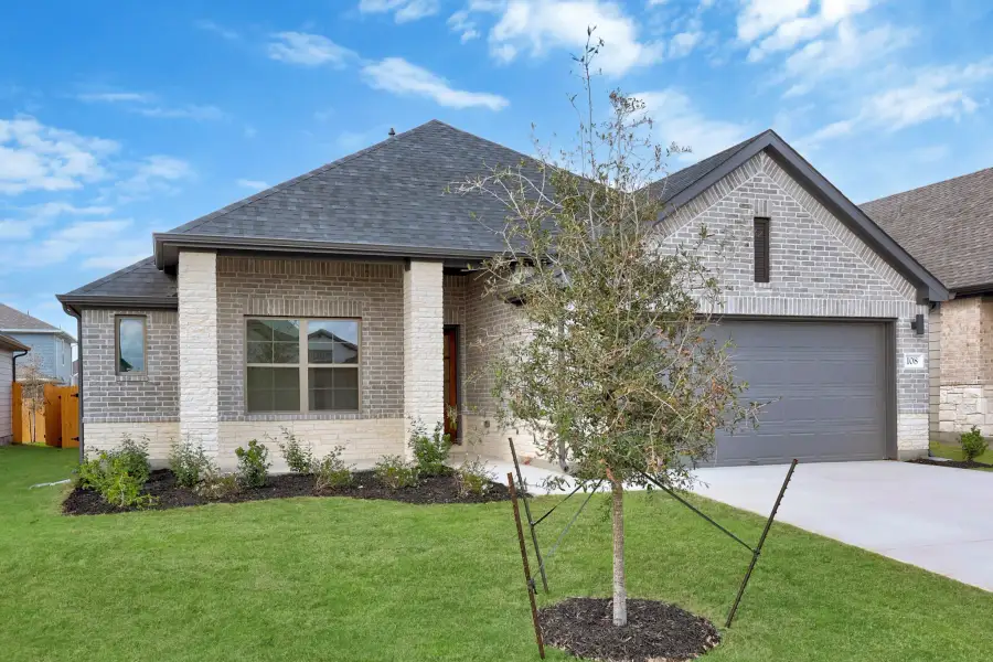 Front exterior of a new home in Prairie Winds, Hutto, TX, highlighting curb appeal (Image 17).