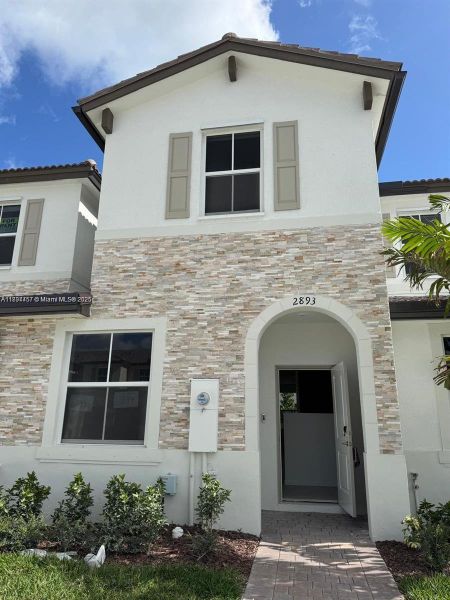 Front exterior of a new home in , Homestead, FL, highlighting curb appeal (Image 2). Front exterior of a new home in , Homestead, FL, highlighting curb appeal (Image 2).