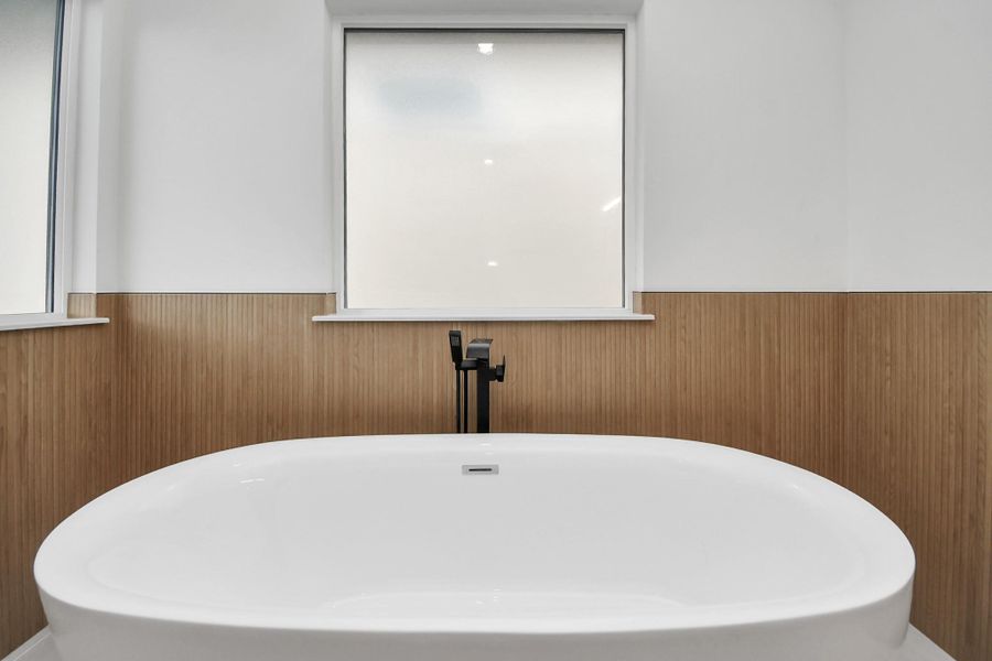 Modern freestanding tub surrounded by wood look tile and a frosted window for privacy. This is just what you need after a long day. Modern freestanding tub surrounded by wood look tile and a frosted window for privacy. This is just what you need after a long day.