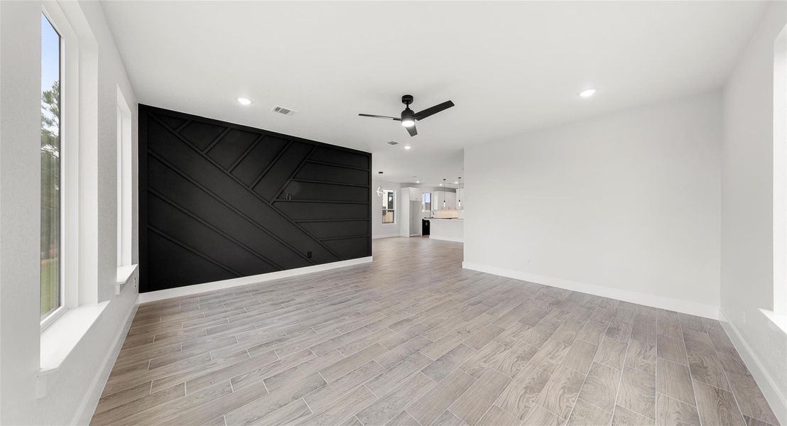 Unfurnished room with wood finish floors, ceiling fan, and recessed lighting